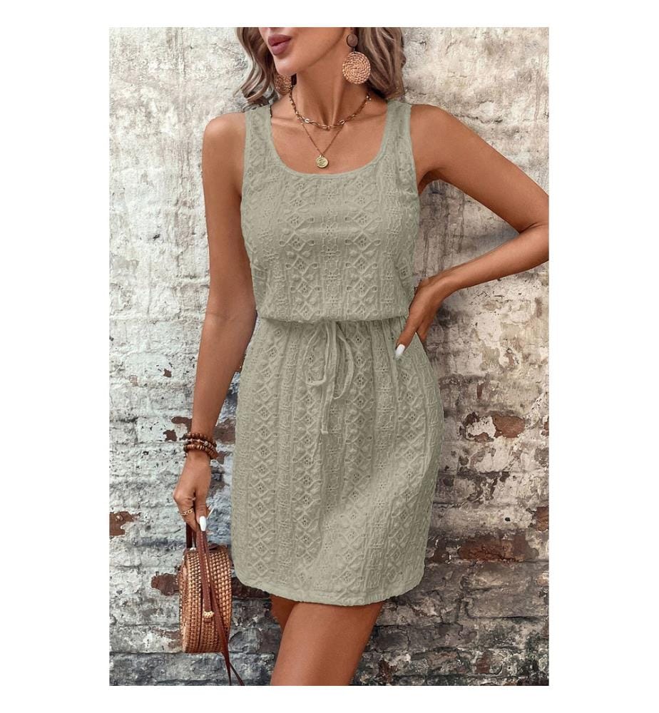 Textured eyelet mini dress with square collar and drawstring, adorned with a four-leaf clover